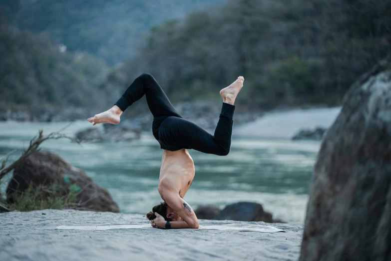 a woman standing upside down while doing yoga poses