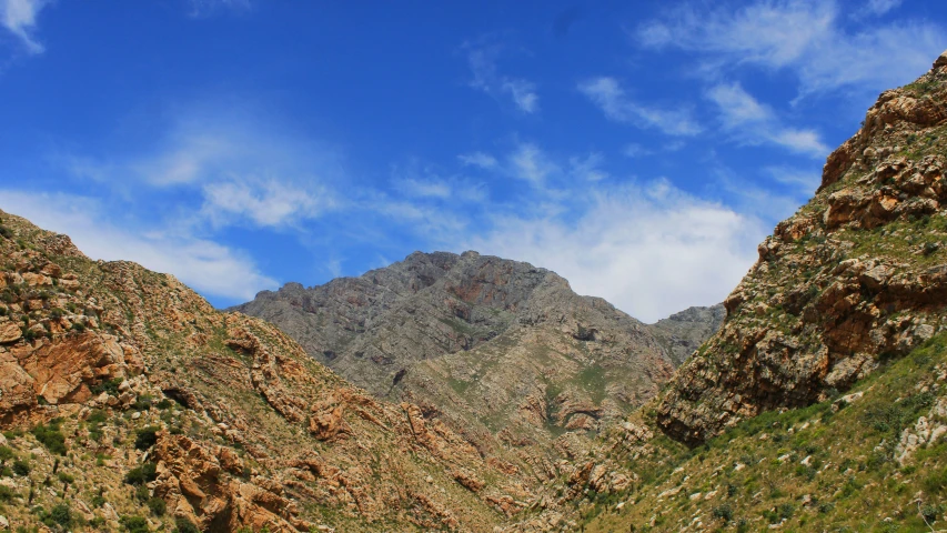 two very tall rocky hills with a sky background