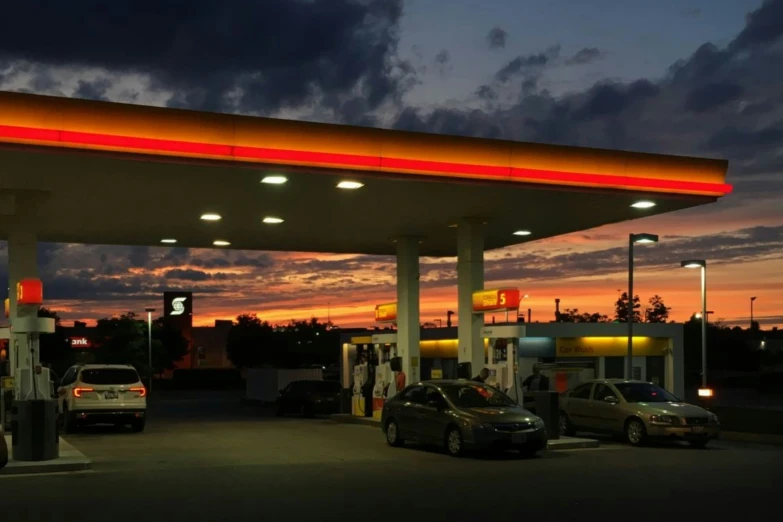a car waits at the gas station at night