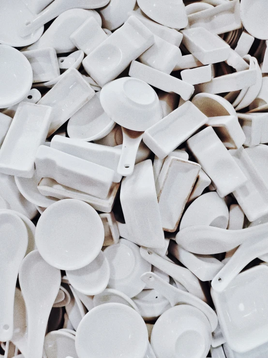 a large pile of white porcelain pieces