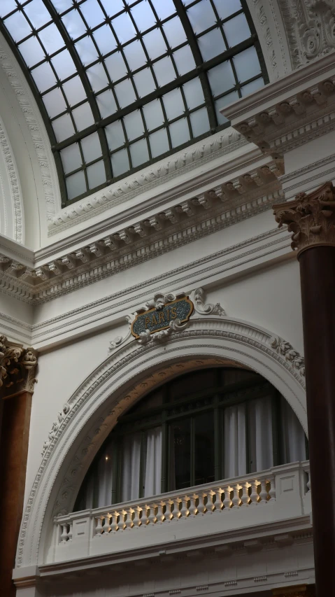 an elegant interior looking up at the windows and the ceiling