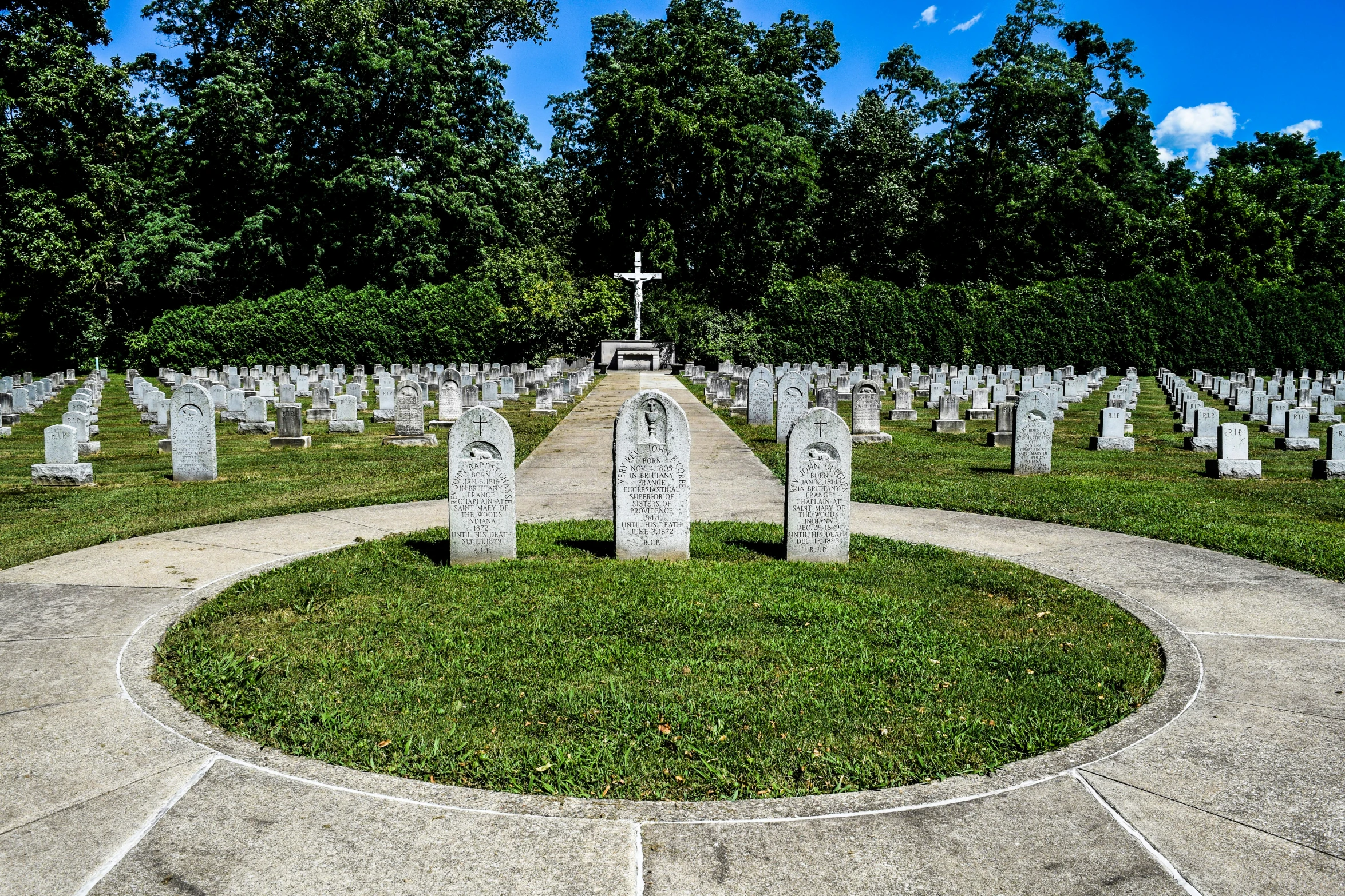 a small cemetery with many headstones and trees