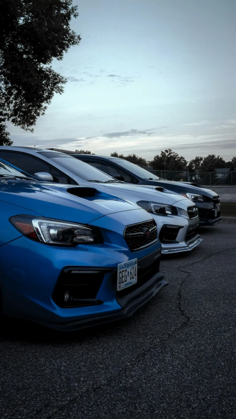 the front end of three different colored cars