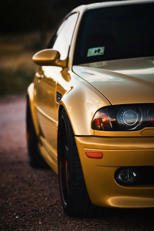 close up view of the front of a gold sports car