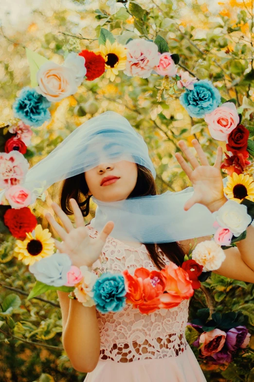 a woman with a scarf around her head and flowers around her