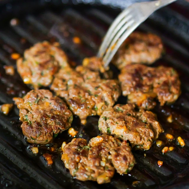 this is a view of some meatballs being cooked on a grill