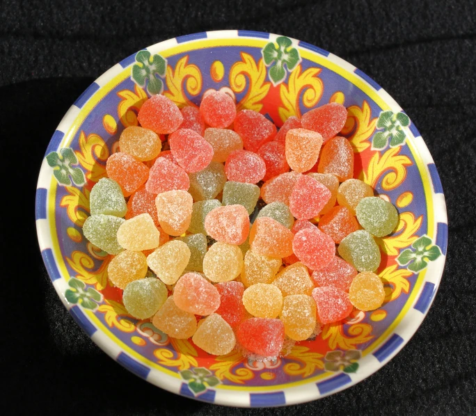 many gummy bears are in a colorful bowl