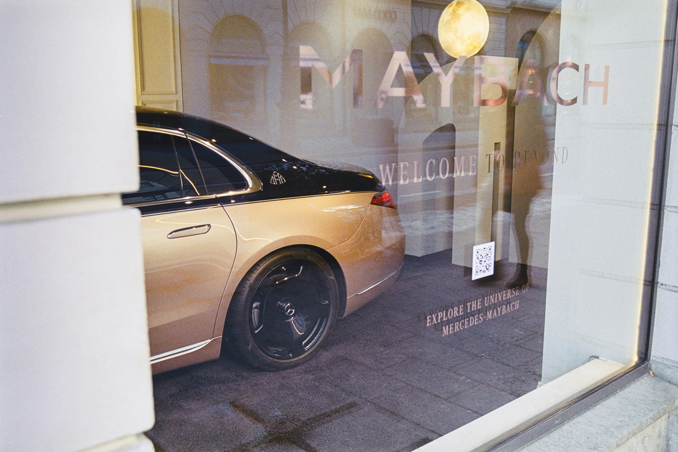 a brown car is sitting in front of a store window