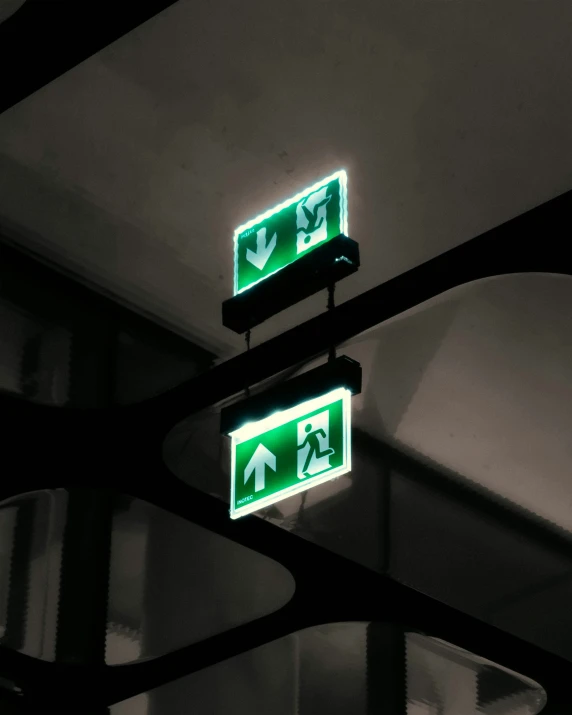 a black and white po of two green directional signs