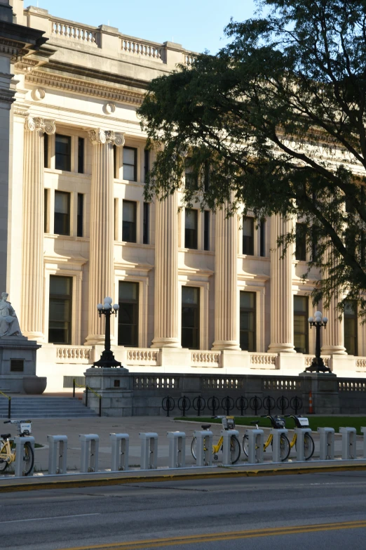 a large building with tall white columns and a clock at the base