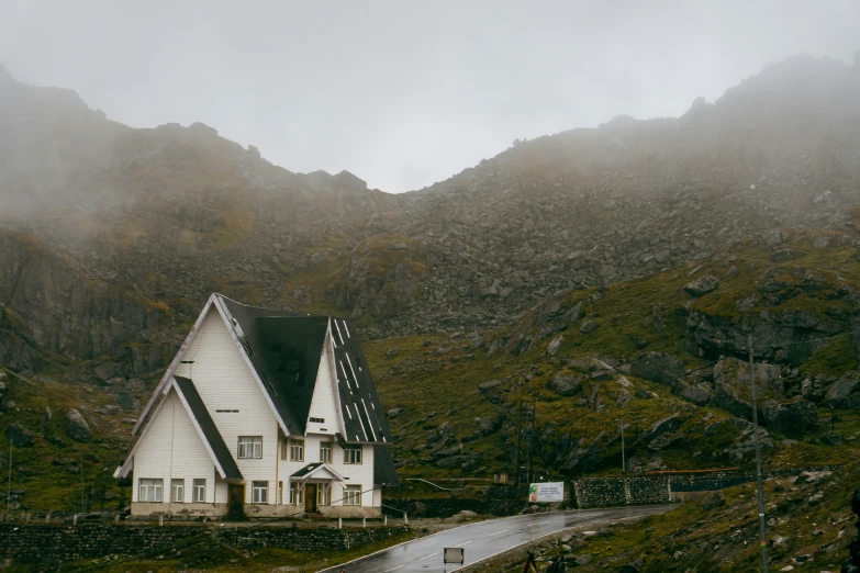 a very large house sitting on top of a hill