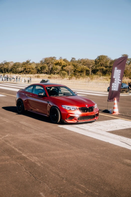 a red car driving through an obstacle course