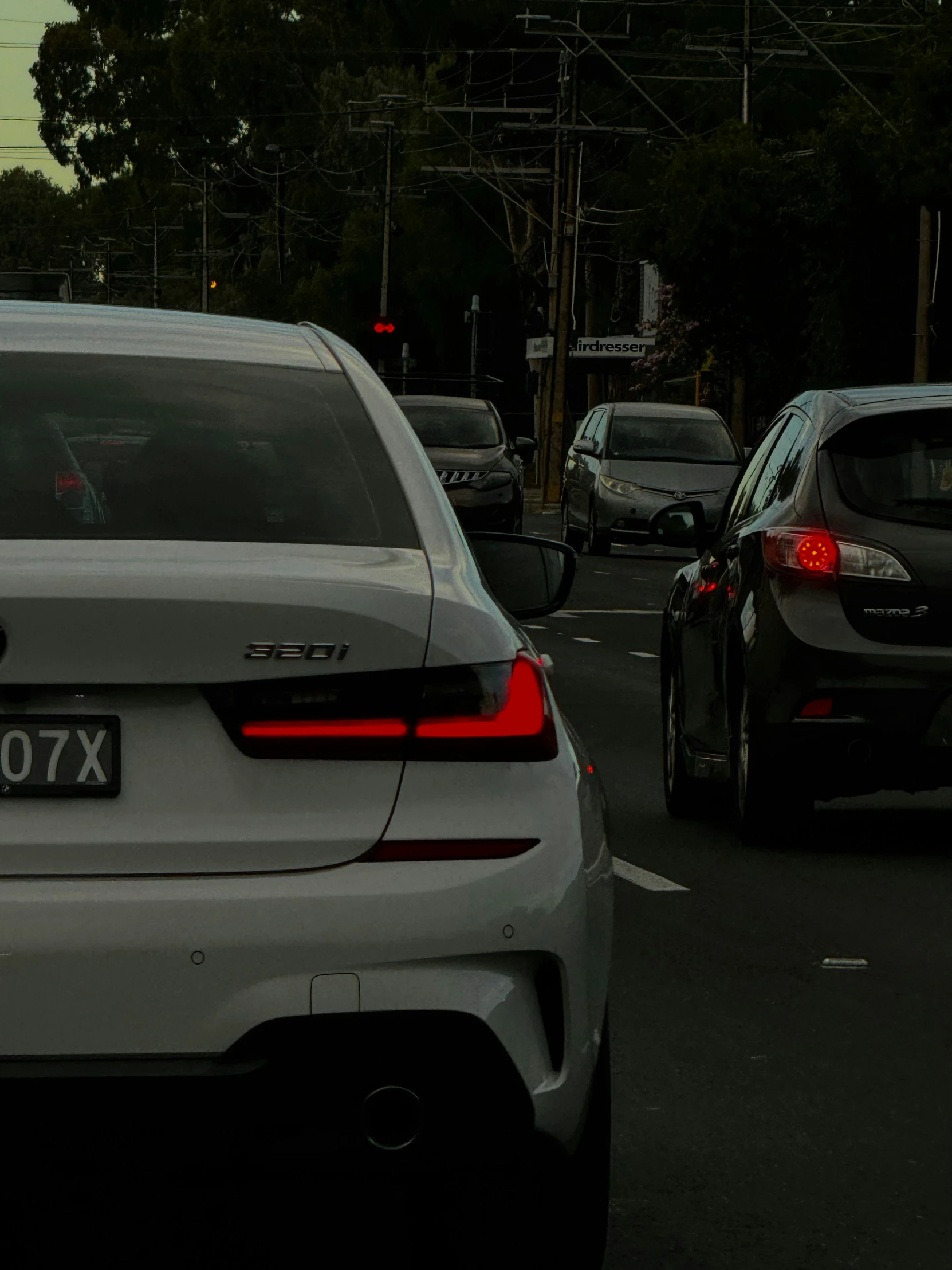 a city street with cars stopped at a red light