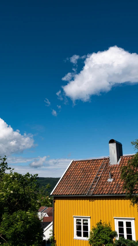 an orange and red house on a hill in the country side