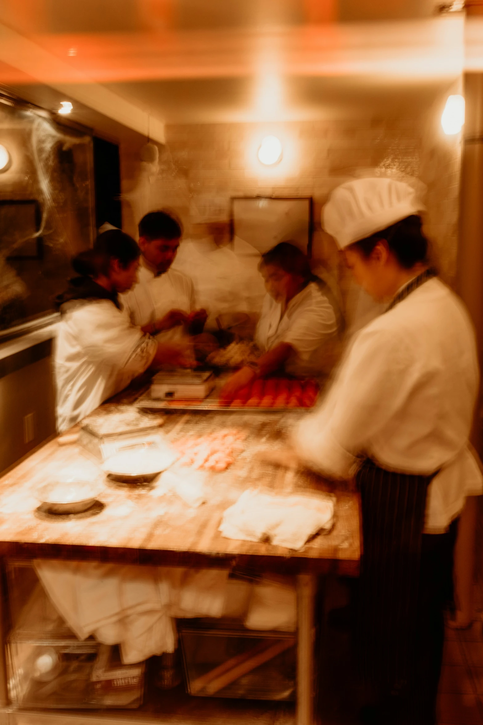 a group of men in the kitchen preparing food