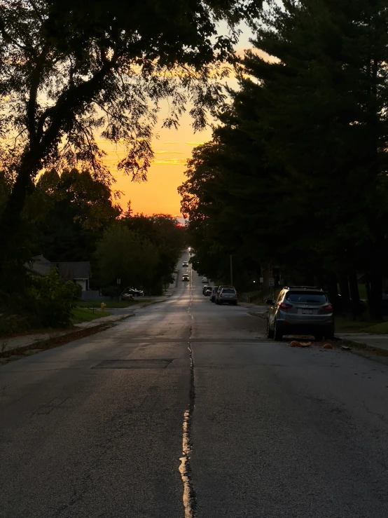 a picture of a deserted street as the sun is setting