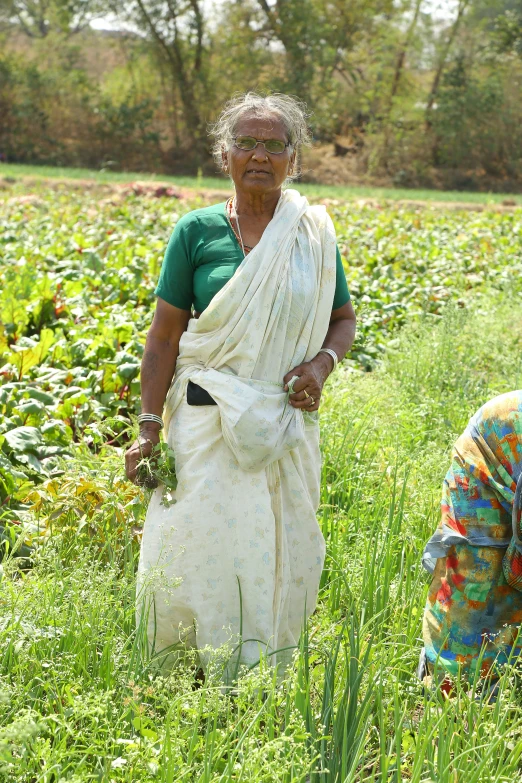 two women standing in a field near each other