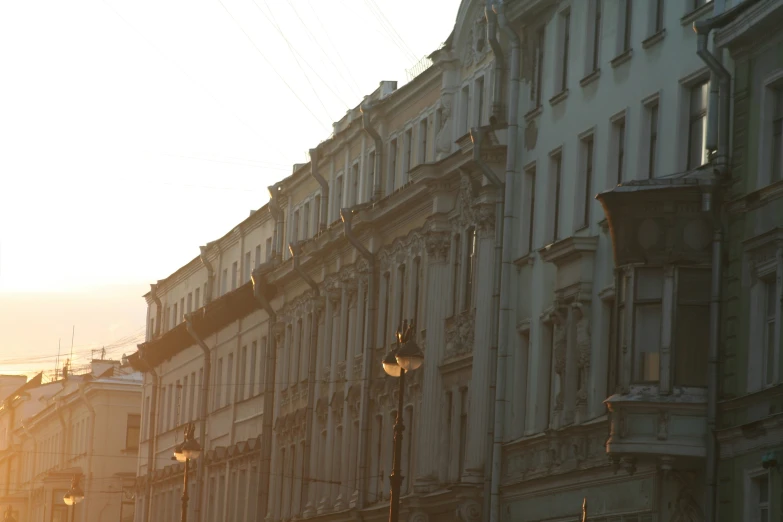 buildings are along side a street with many lights on it