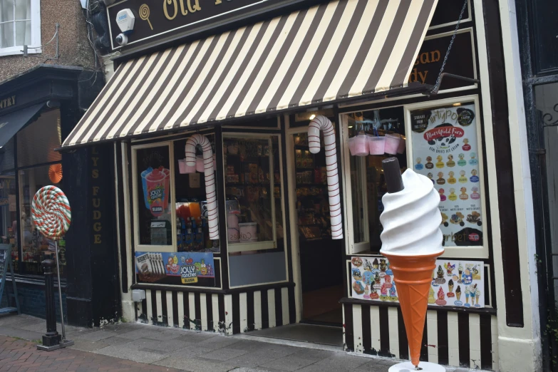 an ice cream shop is open on the sidewalk