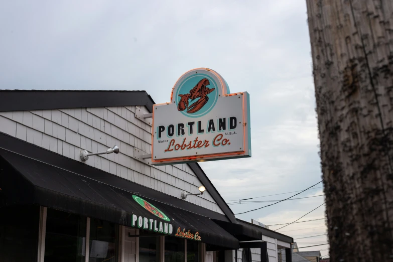 a big sign on a white building that is in front of a store