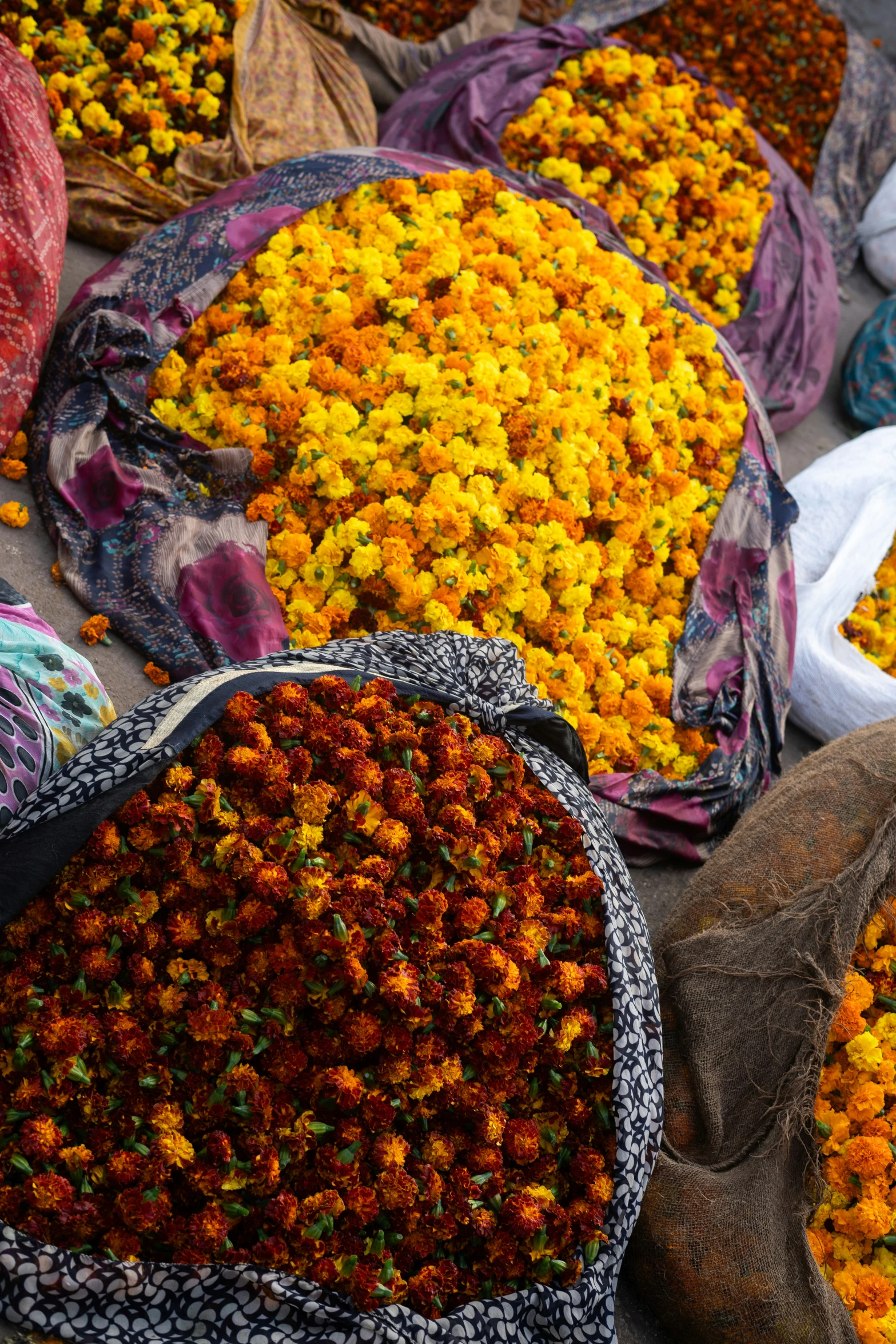 many bags of flowers are stacked on top of each other