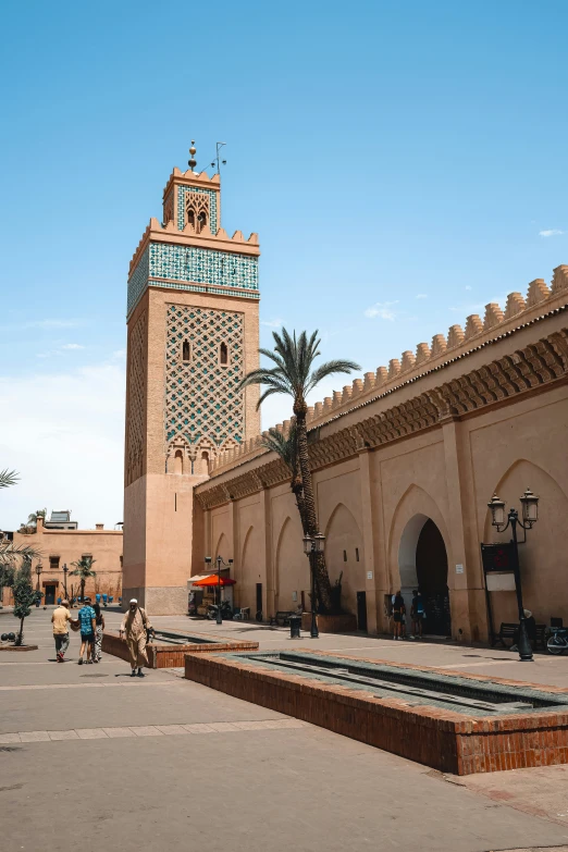 people are walking towards a building in morocco