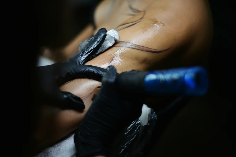 an artistic view of a tattoo being applied