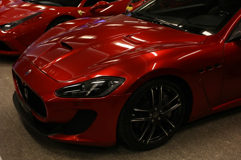 a large red sports car parked next to another car