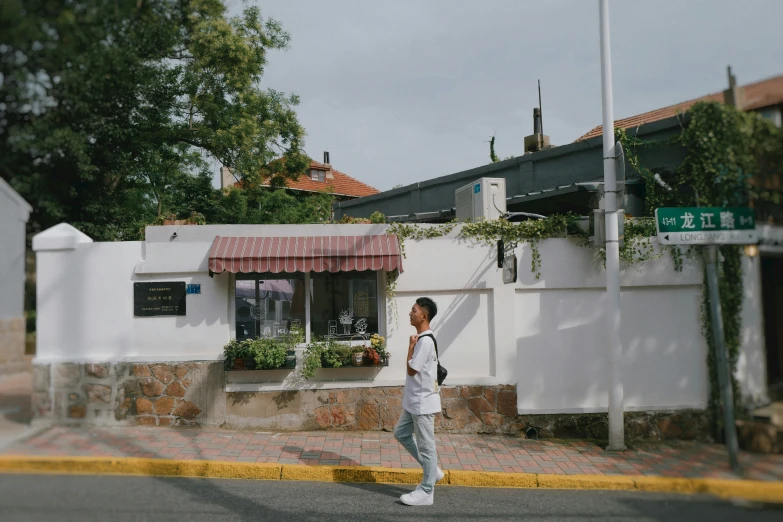 a young man walking across the street