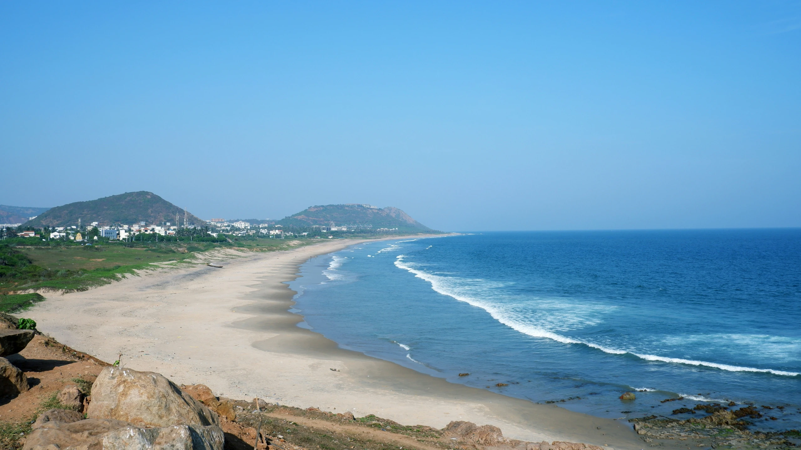 the ocean is a sunny and sandy beach