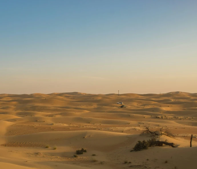 some sort of landscape with vehicles on the top and sand on the ground