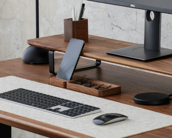 a laptop with keyboard and mouse rest on a desk