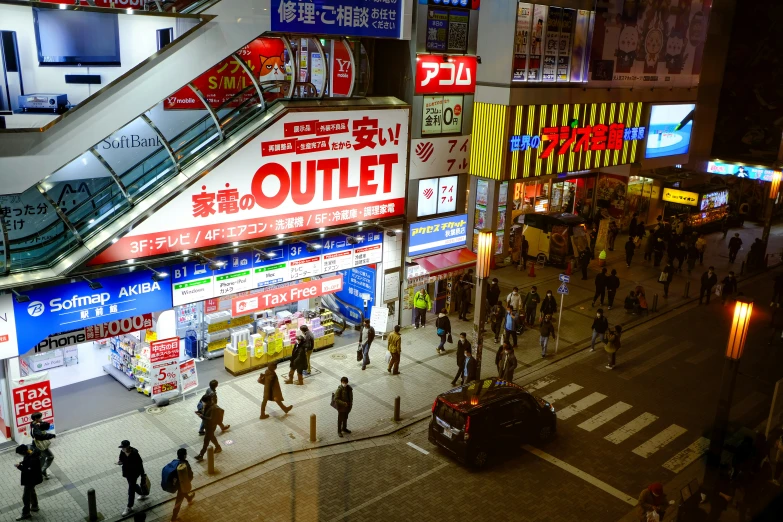 several people walking down an asian street in a city