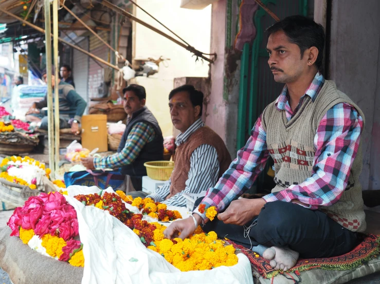 a man is preparing flowers on the street