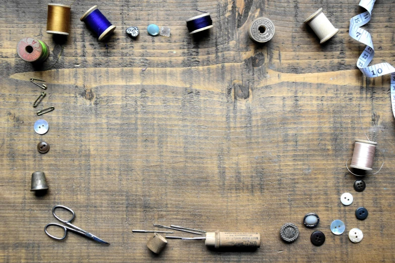 a bunch of sewing supplies are laying out on the ground