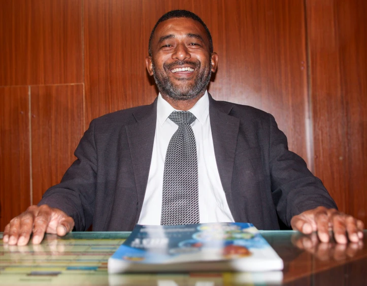 a business man is standing behind a desk