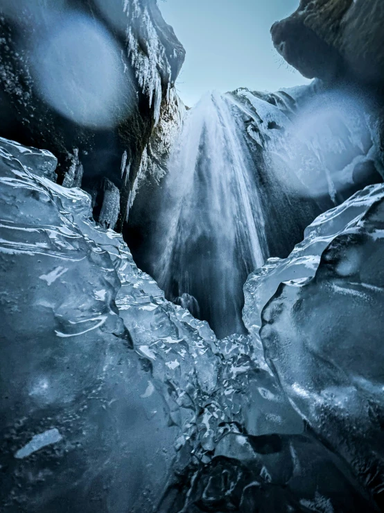 ice is on the ground with mountains in the background