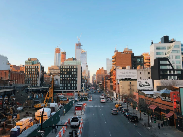 the view of a city street with a traffic light on one side and skyscrs in the background