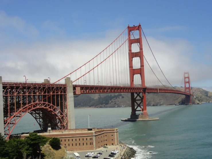 a bridge spanning over water with cars passing by