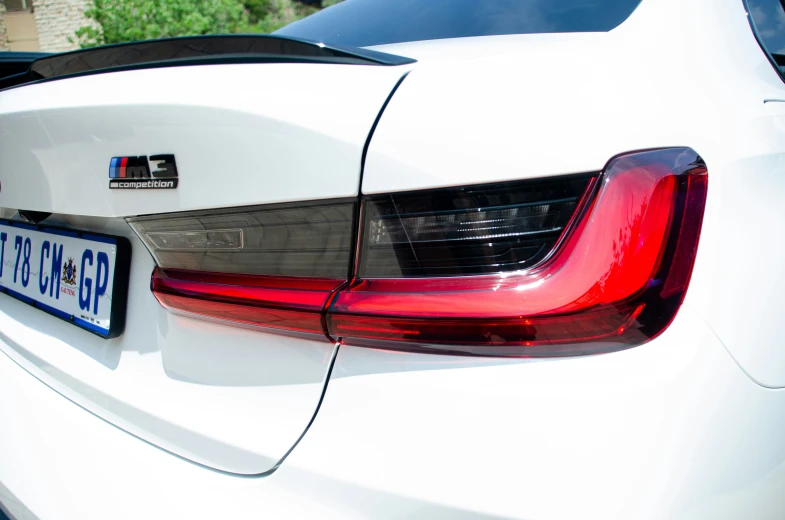 a close up s of the tail lights and rear ke lights of a white bmw