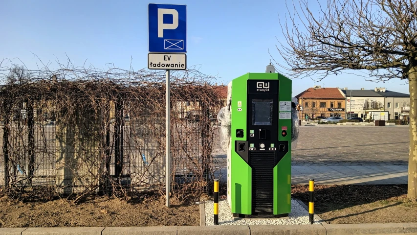 a parking meter on a curb near a parking space