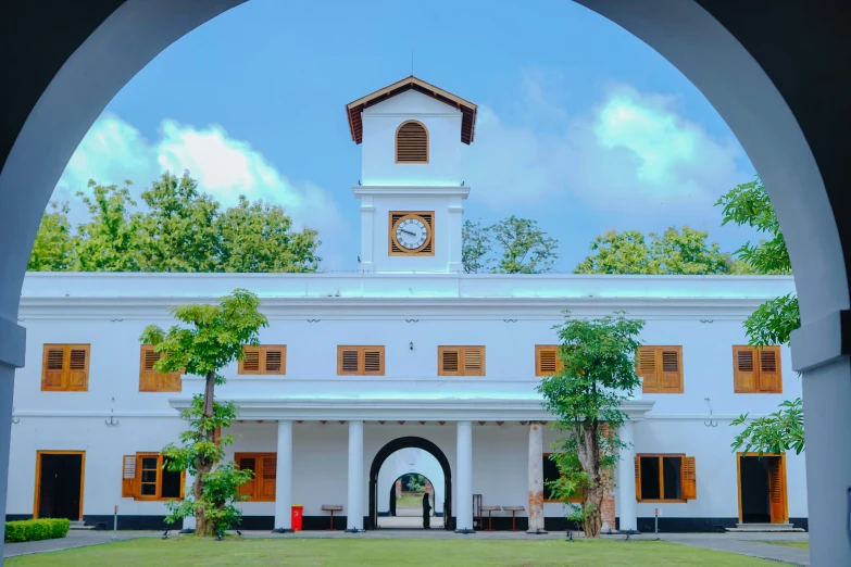 the large white building has a clock on it's side