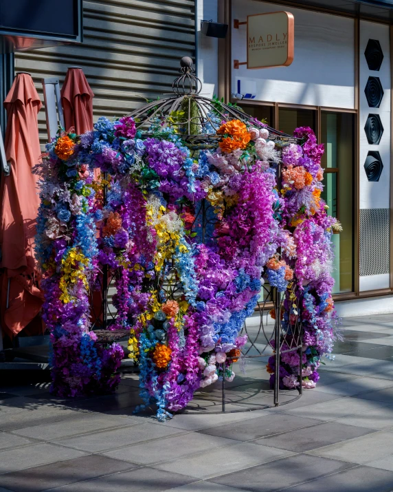 colorful flowers piled on top of each other in front of store