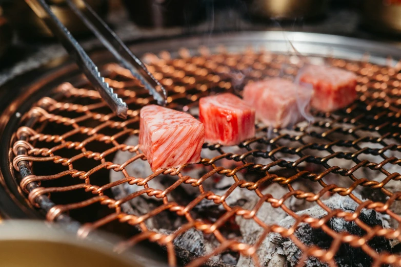 chopsticks sticking up at the bottom of some meat