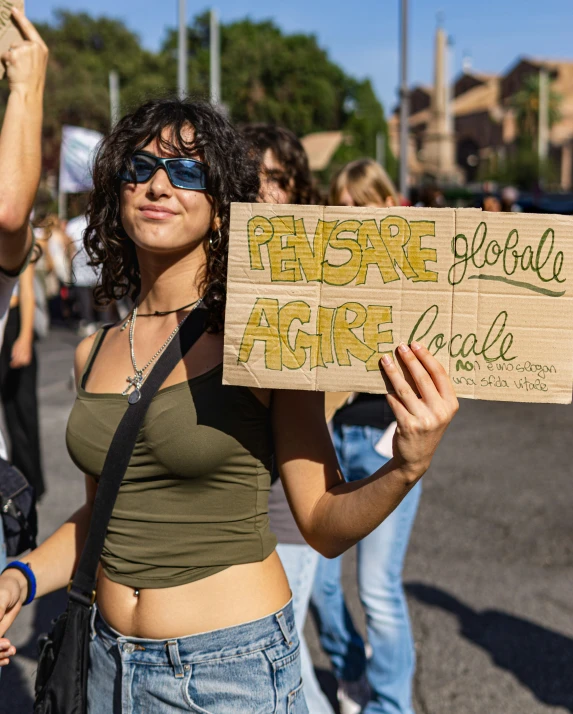 a woman holds up a sign at a protest