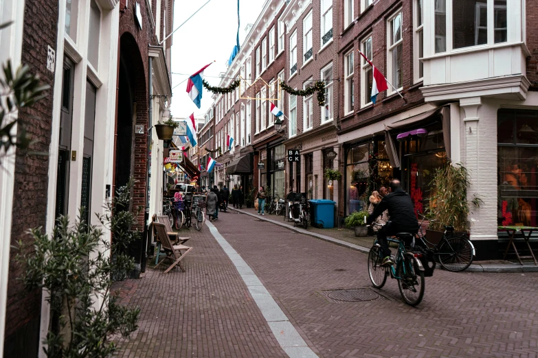 a street with many buildings in it and bicycle riders