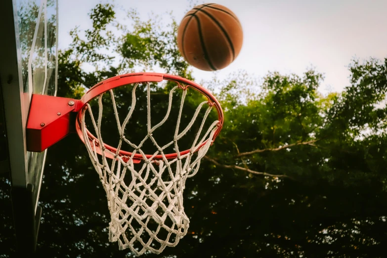 basketball going up through the net of a basketball court