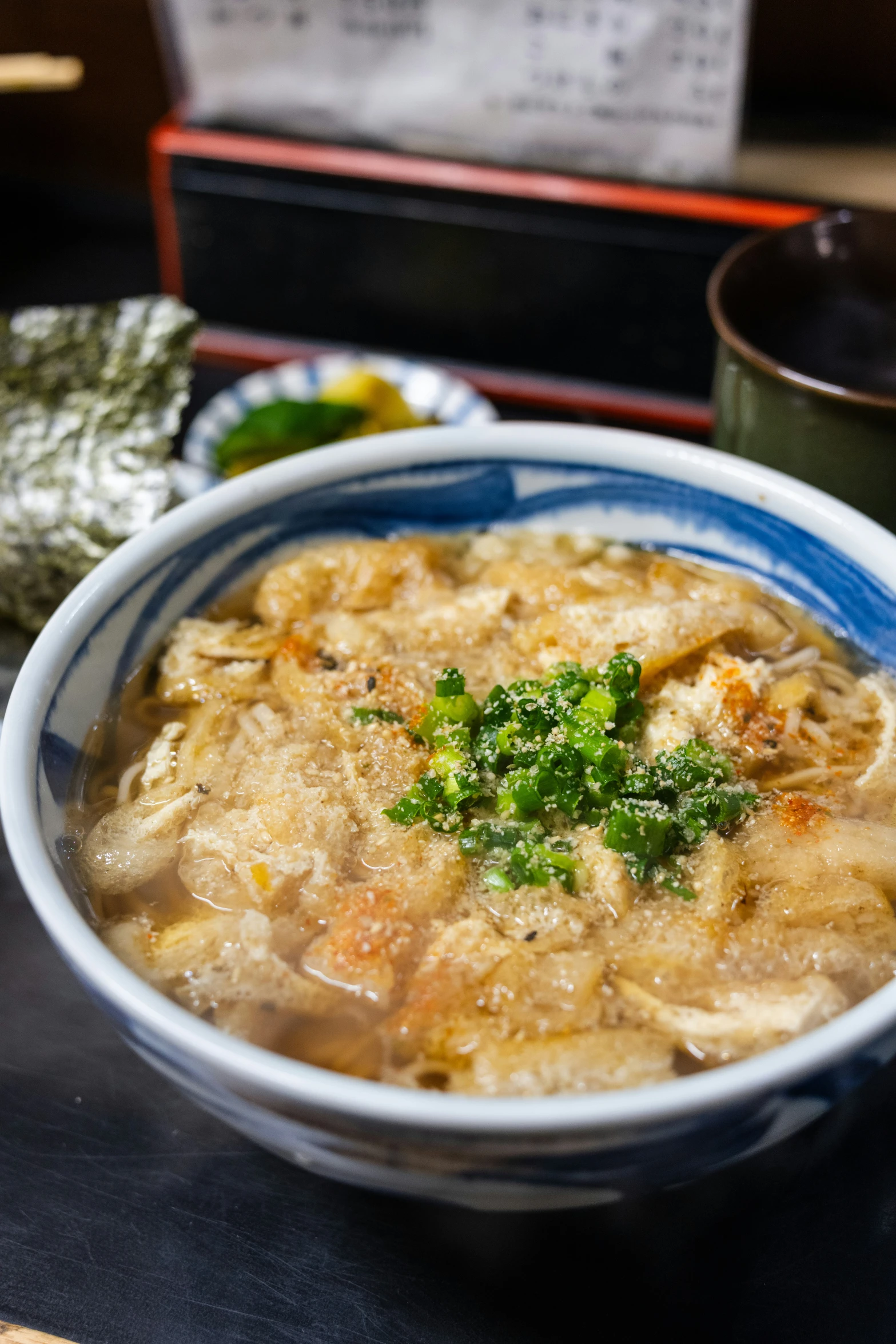 bowl of soup with a spoon on the side