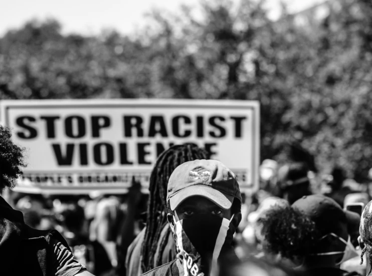 a group of people standing around and holding signs