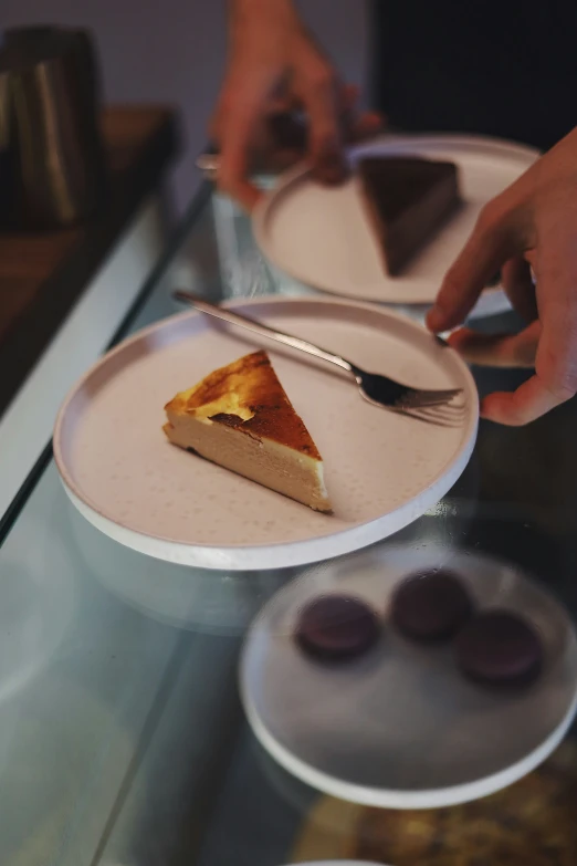 the man is holding the knife and fork next to the plate that is on the counter